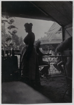 Woman in a beer tent, looking out