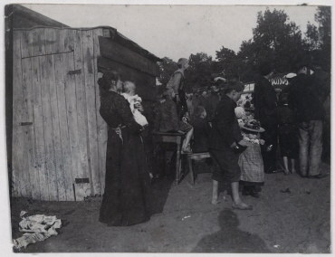 Amusement Park, Woman With Her Child in Front of a Latrine